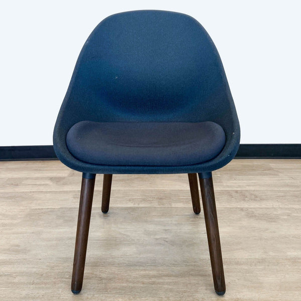 IKEA Baltsar upholstered dining chair with curved backrest and modern wooden legs, frontal view.