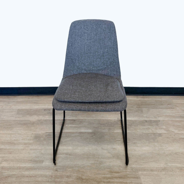 Reperch modern grey fabric dining chair with cushioned seat and black metal legs, front view.