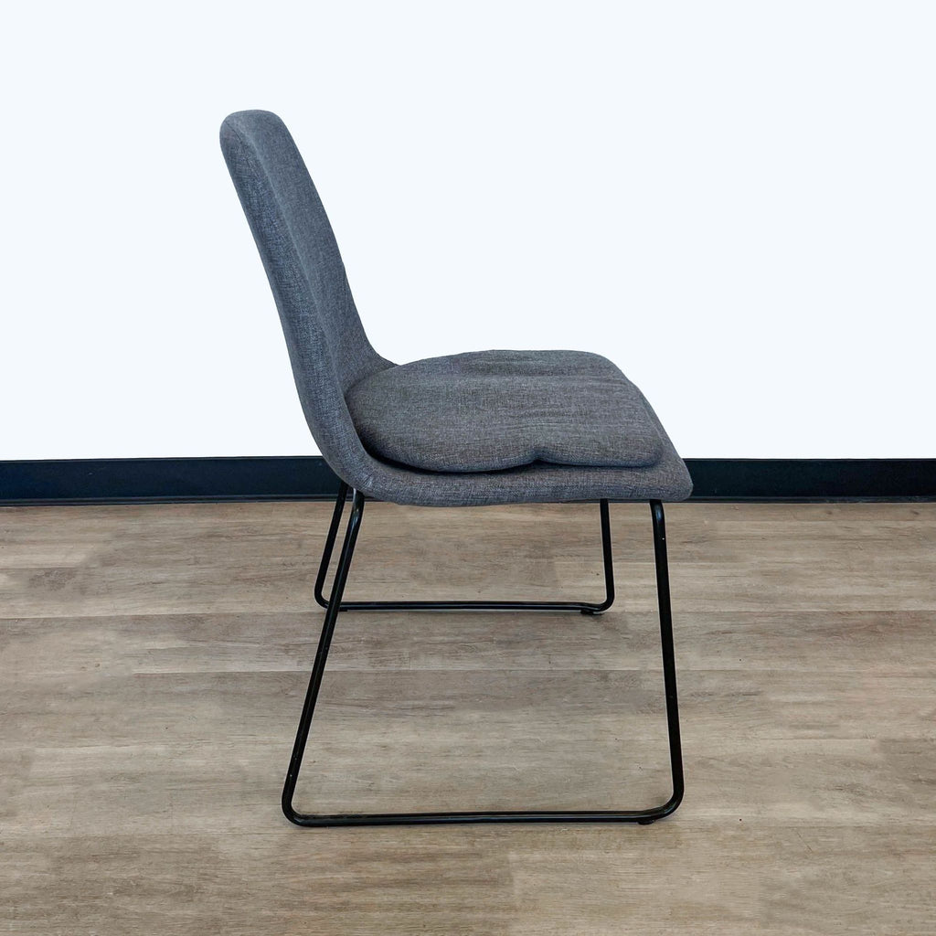 Sleek side view of Reperch grey upholstered dining chair with a supportive backrest and metal frame.