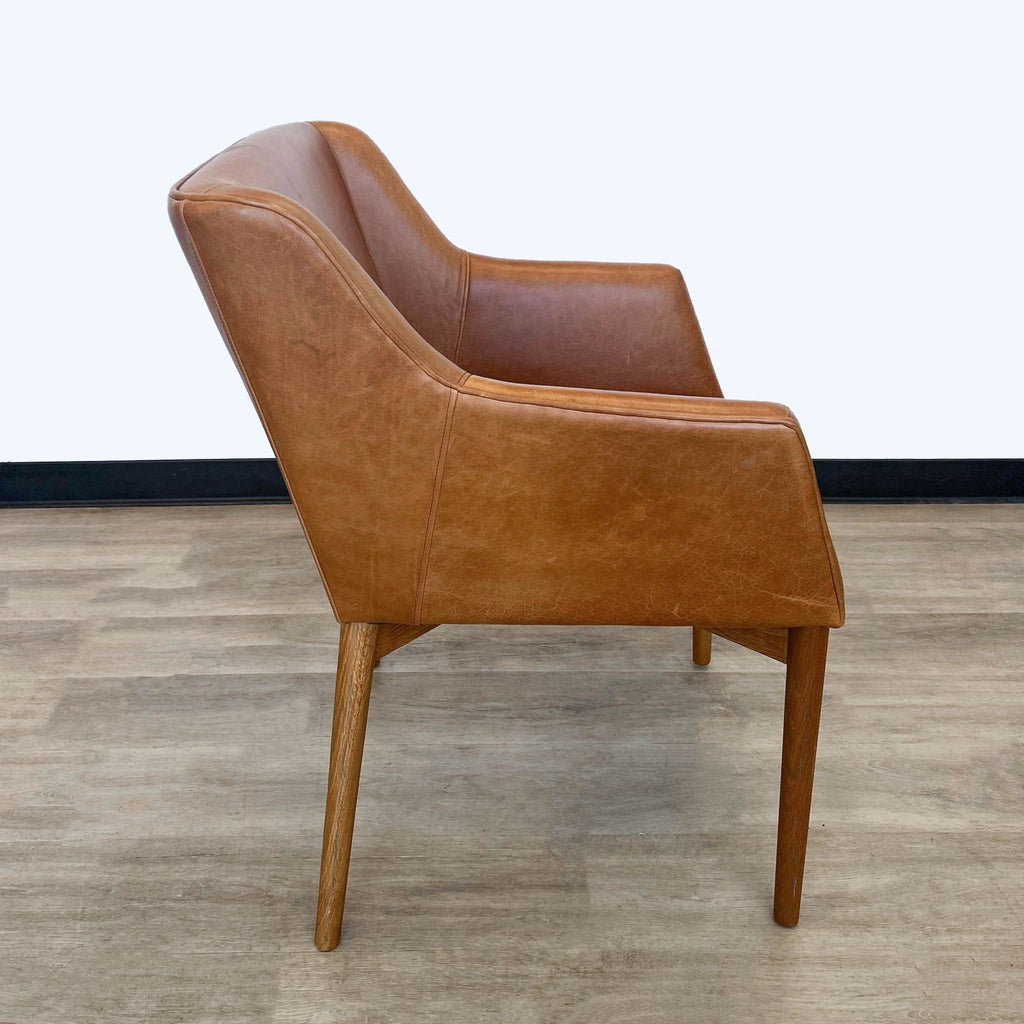 Side angle of a Square Roots Kepi lounge chair, highlighting the clean lines and leather texture.