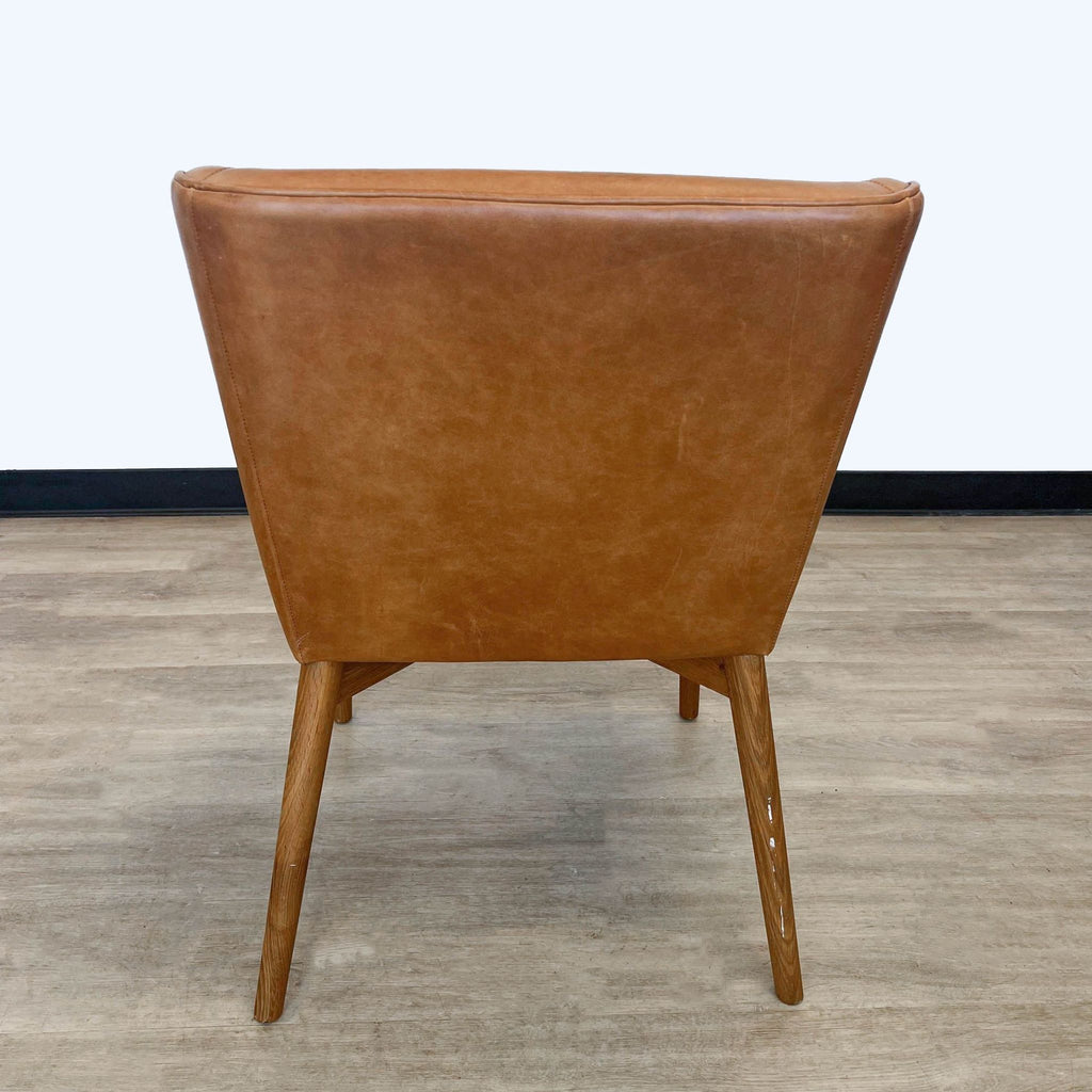Rear view of a Square Roots Kepi chair showcasing the streamlined design and wooden legs.