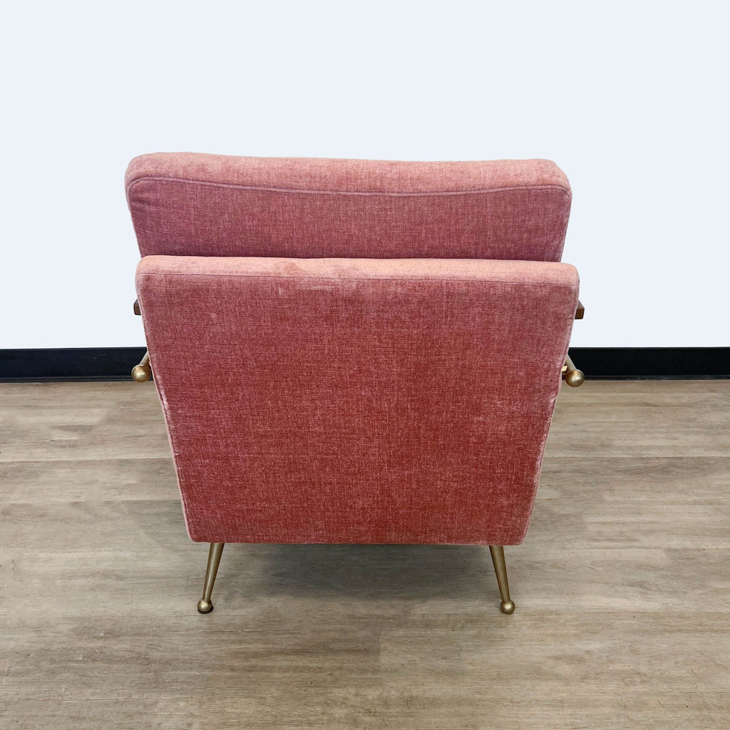 a pair of red velvet lounge chairs