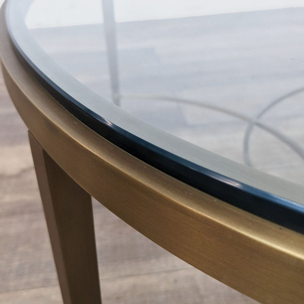 3. Close-up of the edge detailing on a Thomas Pheasant coffee table, featuring the smooth antique brass finish and glass interface.