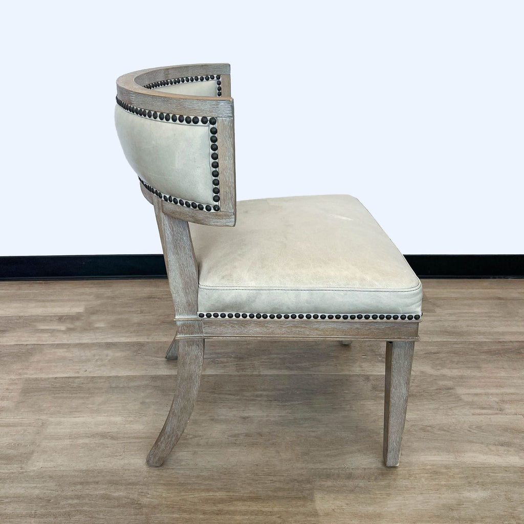Side view of a leather-upholstered Carter accent chair with wood frame and nailhead details from HD Buttercup.