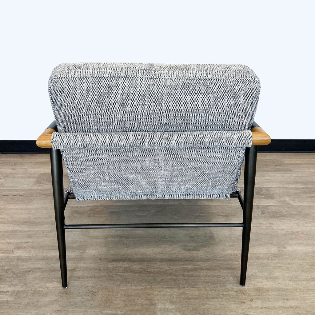 Back view of a contemporary Four Hands lounge chair with a heathered gray textile and a combination of wood and metal frame.