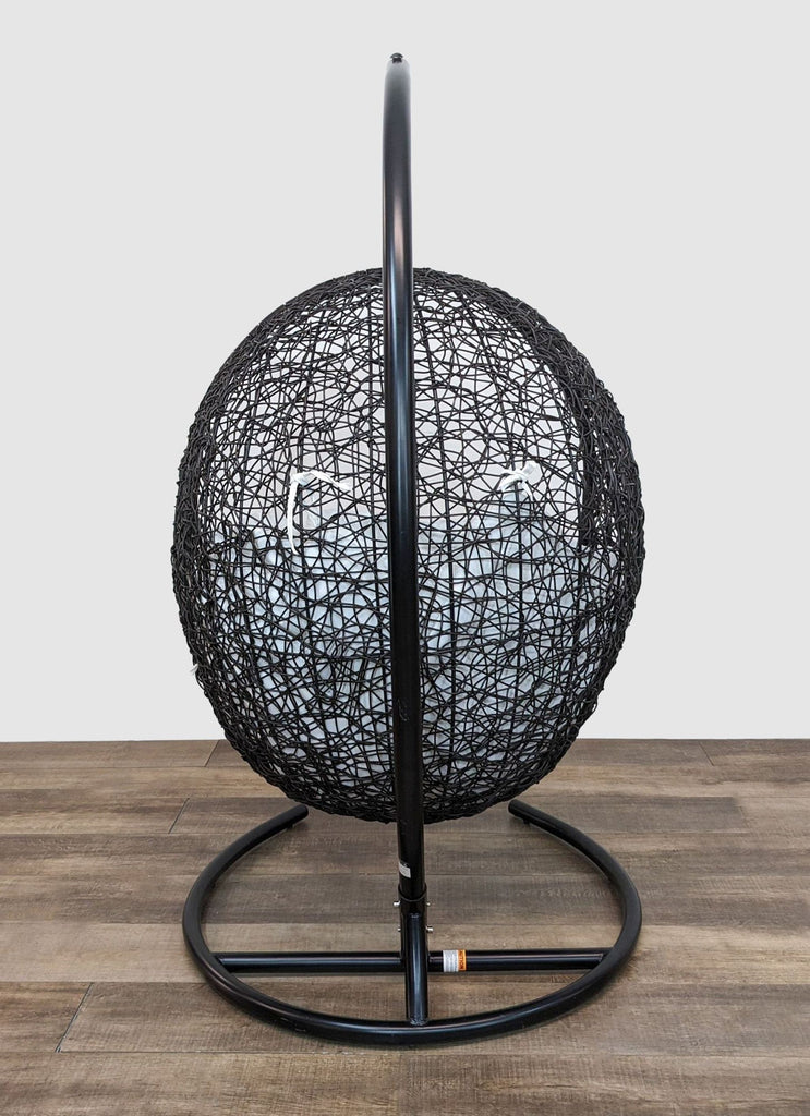 Circular hanging chair by Reperch, made from wicker rattan with powder-coated steel support.