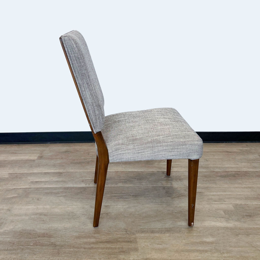 2. A side angle of the Kurt dining chair showcasing its clean lines, upright shape, and the gentle curve of its backrest and legs.