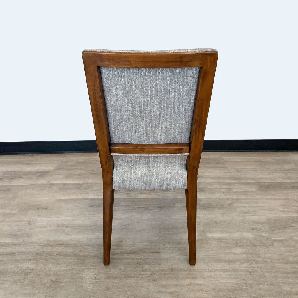 3. The back view of the Four Hands Kurt dining chair, highlighting the open-frame back design and warm, textured fabric.