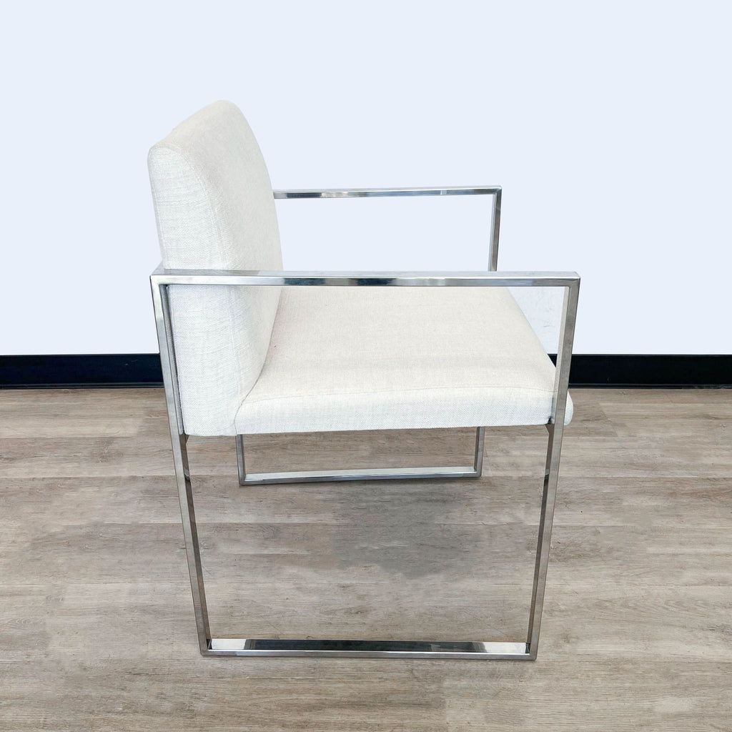 Modern dining armchair by Reperch with sturdy metallic construction and soft linen cushioning.