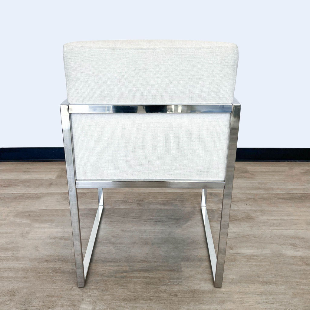 Reperch dining chair showcasing metal frame and comfortable linen upholstery, in a minimalist design.