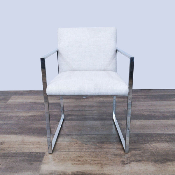Contemporary The Brownstone lounge chair with chrome frame and light fabric upholstery, front view on wooden floor.