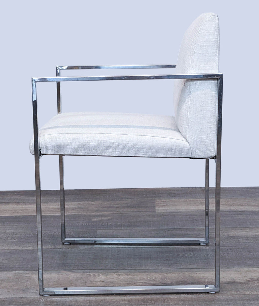Elegant The Brownstone lounge chair with modern design, chrome framing, and soft light upholstery, angle view.