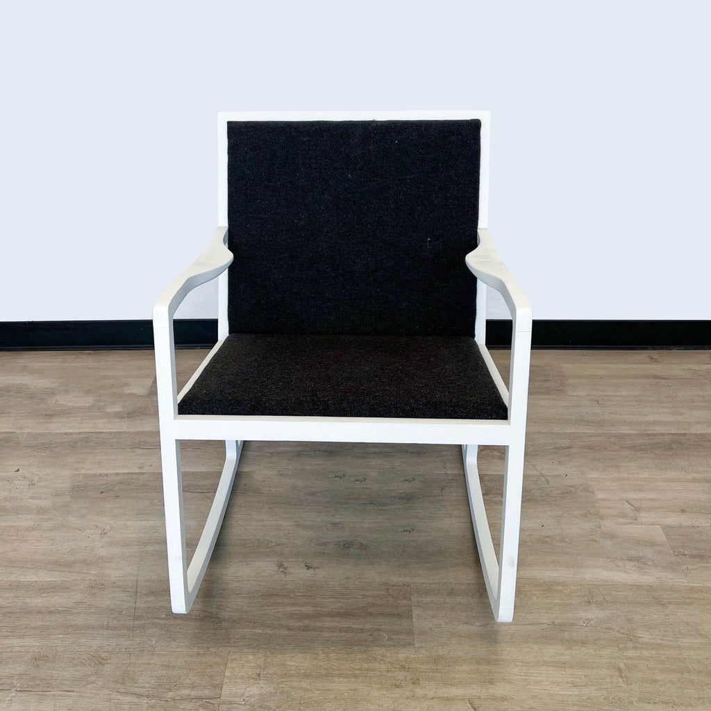 Modern white HD Buttercup rocking chair with black textured cushions.