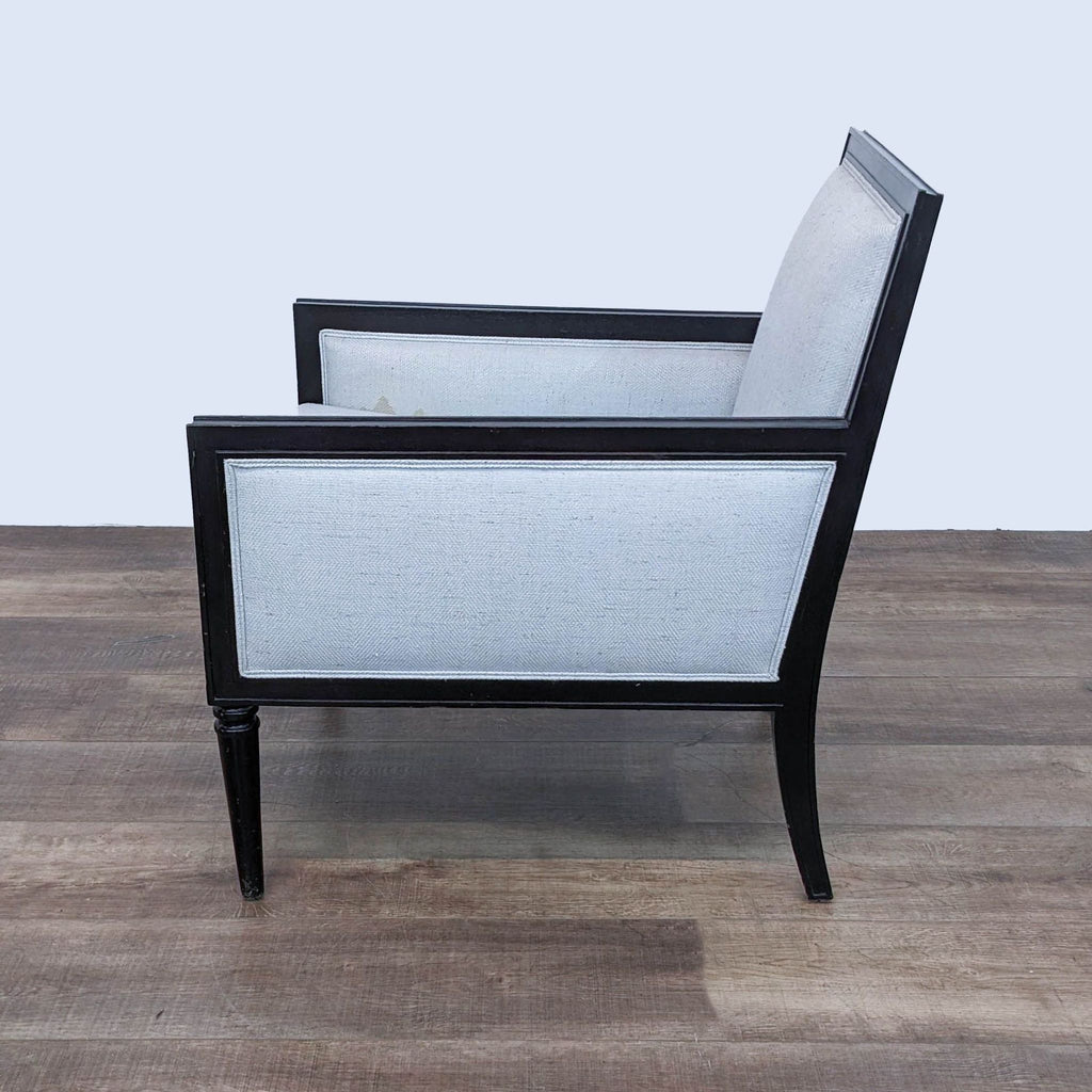 Sleek Black-Framed Lounge Chair with Light Upholstery