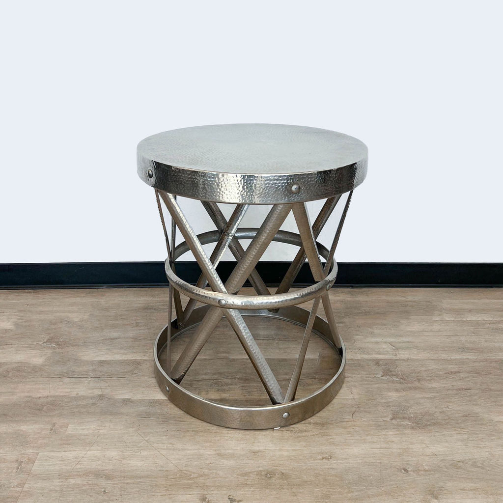 2. Round Reperch console table showcasing textured top and interconnected metal supports, staged on laminate flooring.