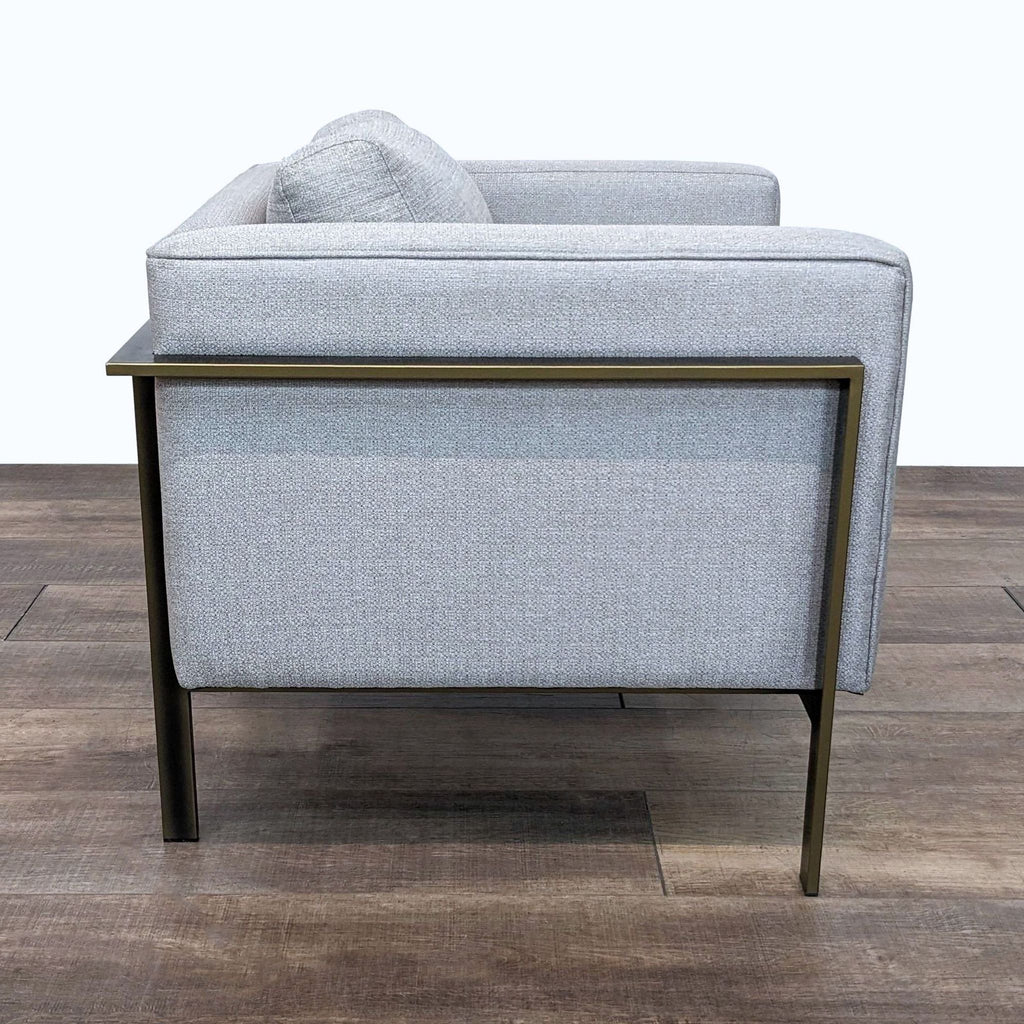 Side profile of a gray single-seater lounge chair with sleek, modern lines.