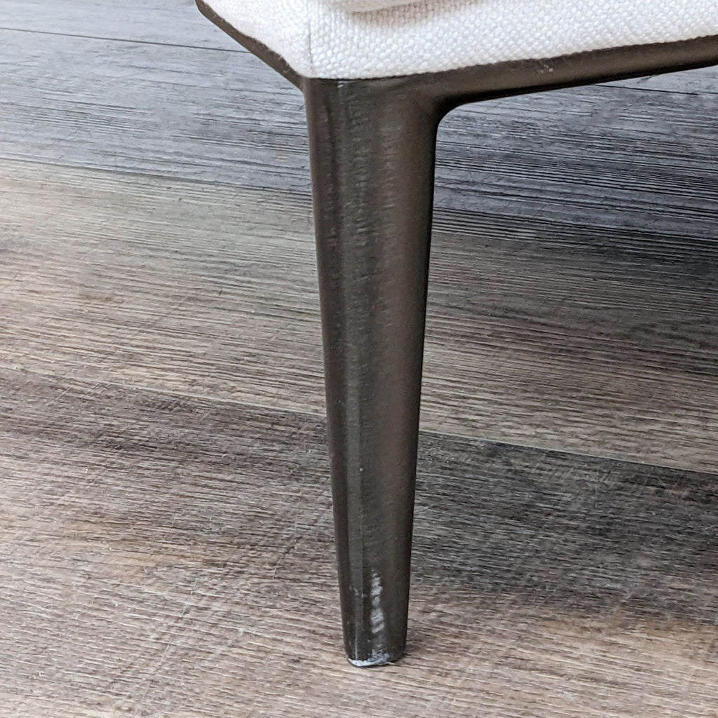 Close-up of the titanium leg of the Abisko chair by Article, enhancing its modern lounge style.