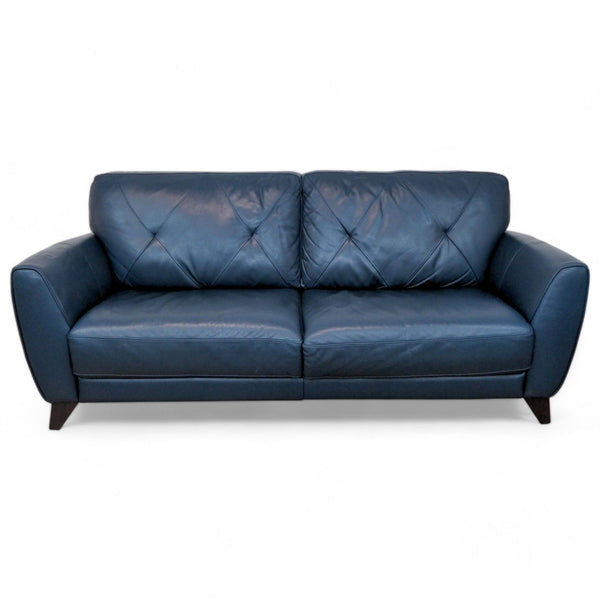 Macy's Miya loveseat in navy blue with plush cushions, flared arms, and tufted diamond-stitched back.