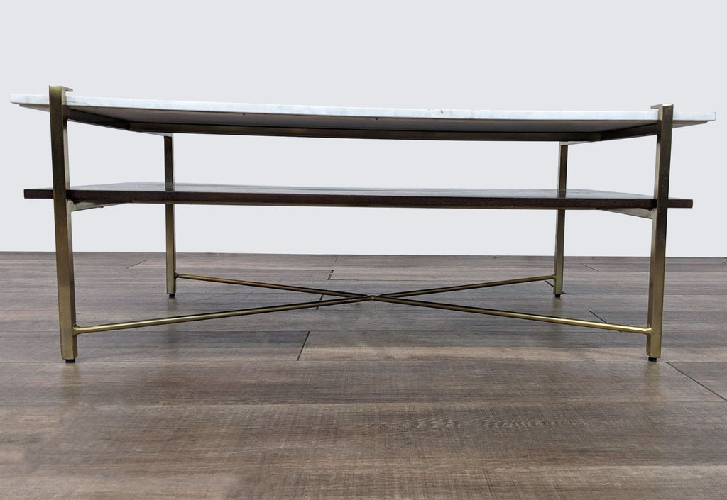 Elegant Anthropologie coffee table, featuring brass iron legs, walnut shelf, and marble surface.