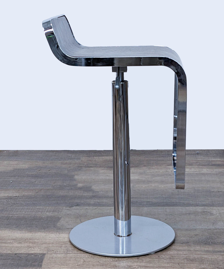 Contemporary stool with a dark wood veneer seat, footrest, and shiny chrome adjustable base.