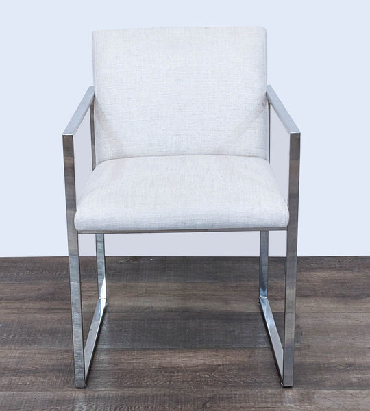 "The Brownstone contemporary dining armchair with sleek metal frame and linen-upholstered seat and back."