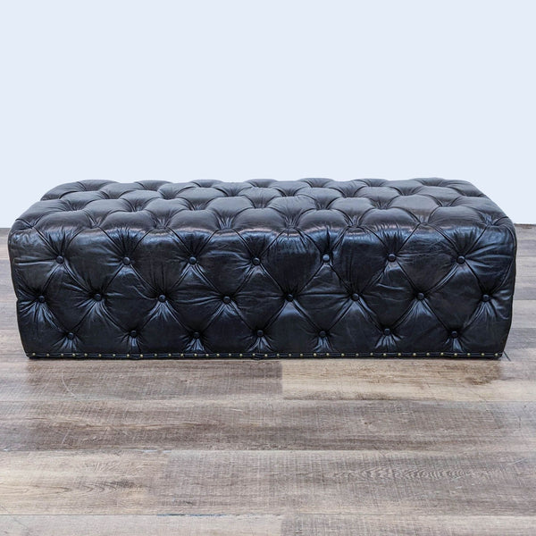 Luxurious tufted bench with brass nailhead trim on wooden floor.