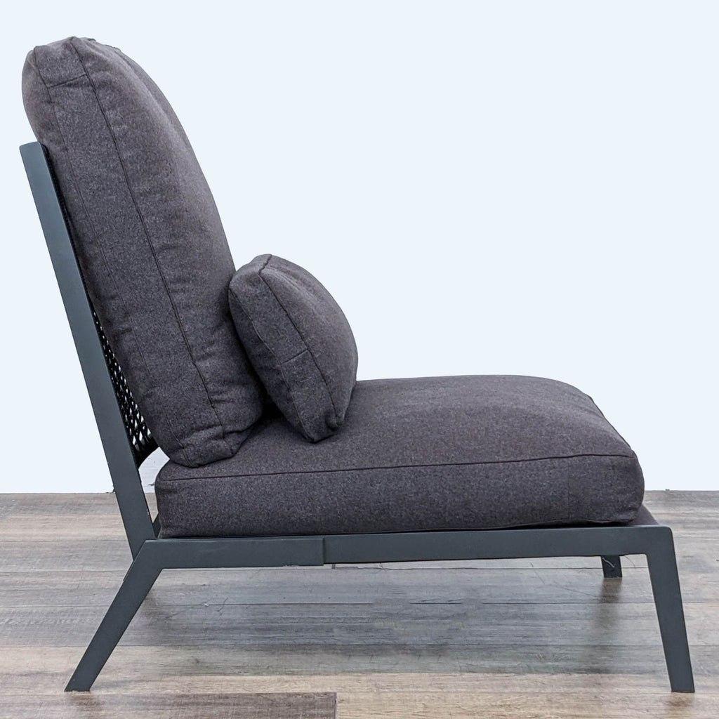 2. Side angle of the Arc Lounge Chair showcasing the woven leather back and plush cushions with a dark grey fabric.