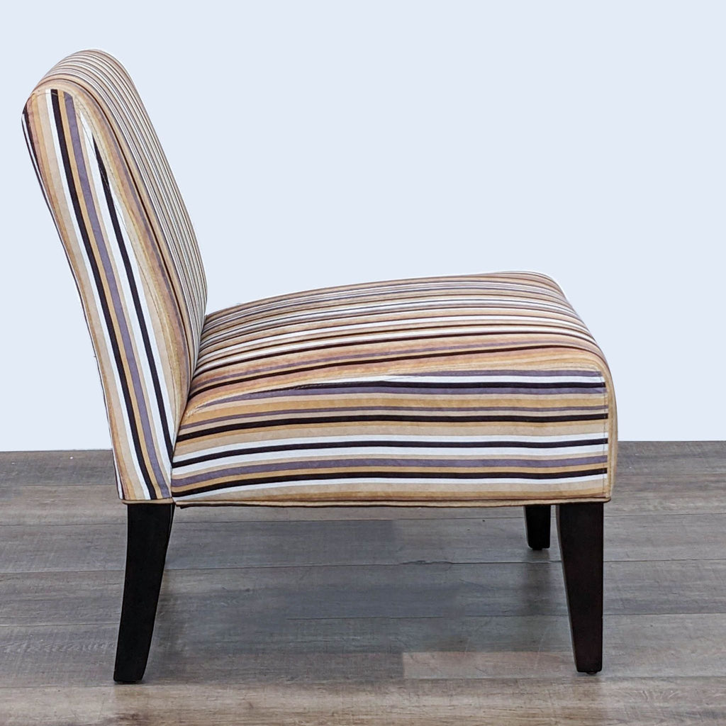 Side view of Reperch striped slipper chair highlighting the curved back and tapered wooden legs.
