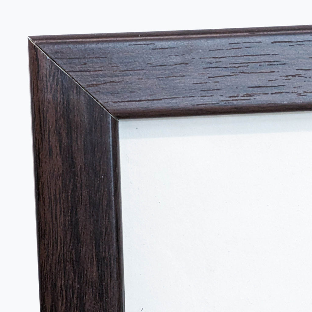 Close-up of a dark brown wooden frame corner.  
