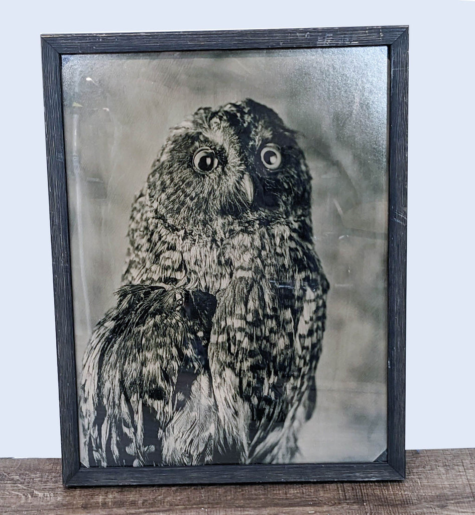 Sepia-toned framed print of an owl, by Reperch, displayed on a wooden surface.
