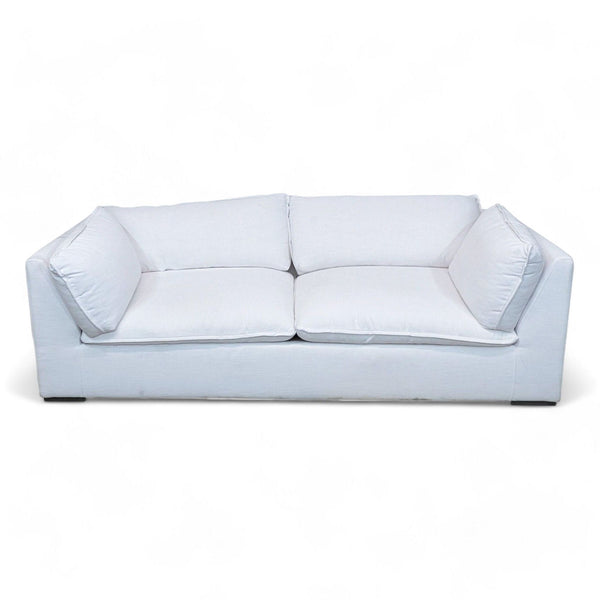 1. Restoration Hardware's Costera sofa, a 3-seater with a minimalist white design, representing '70s Postmodernism, against a white backdrop.