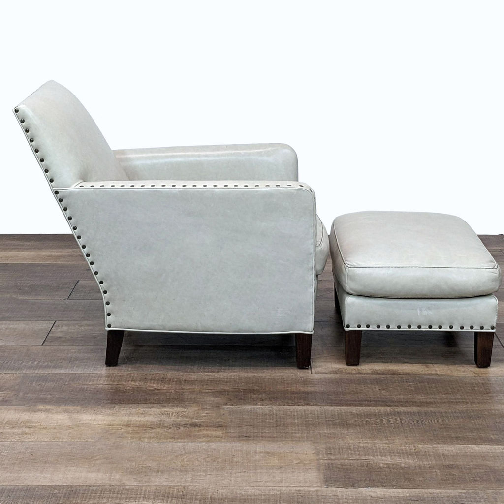 Lee Industries leather lounge chair and matching ottoman in a room setting, with elegant nailhead details on both pieces.