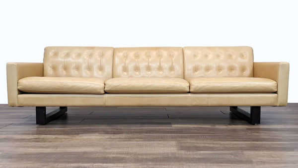 Wells Sofa by Room & Board with button tufting and solid wood base, 3-seat design, in a frontal view.