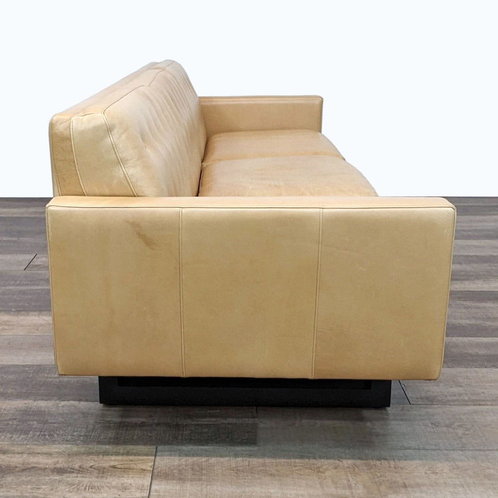 Side view of a 3-seat Wells Sofa showcasing the deep seat, precise stitching, and wood base.