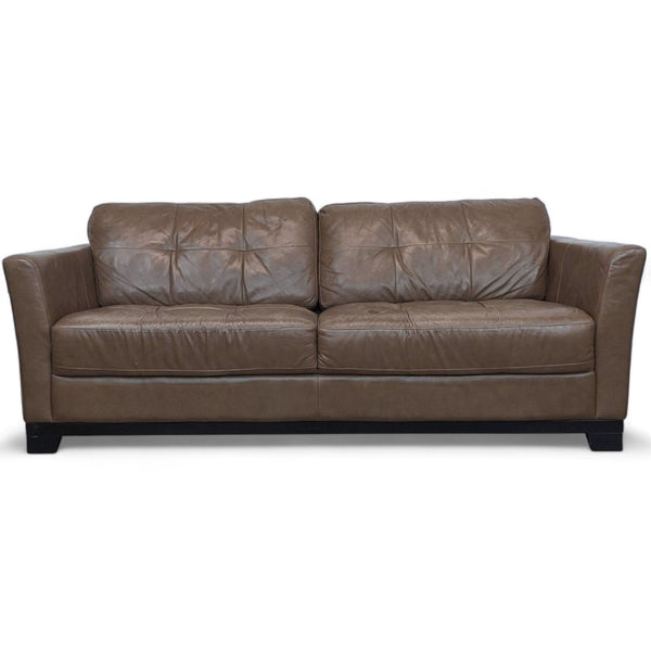 Chateau d'Ax leather loveseat with plush cushions and wooden feet, front view.