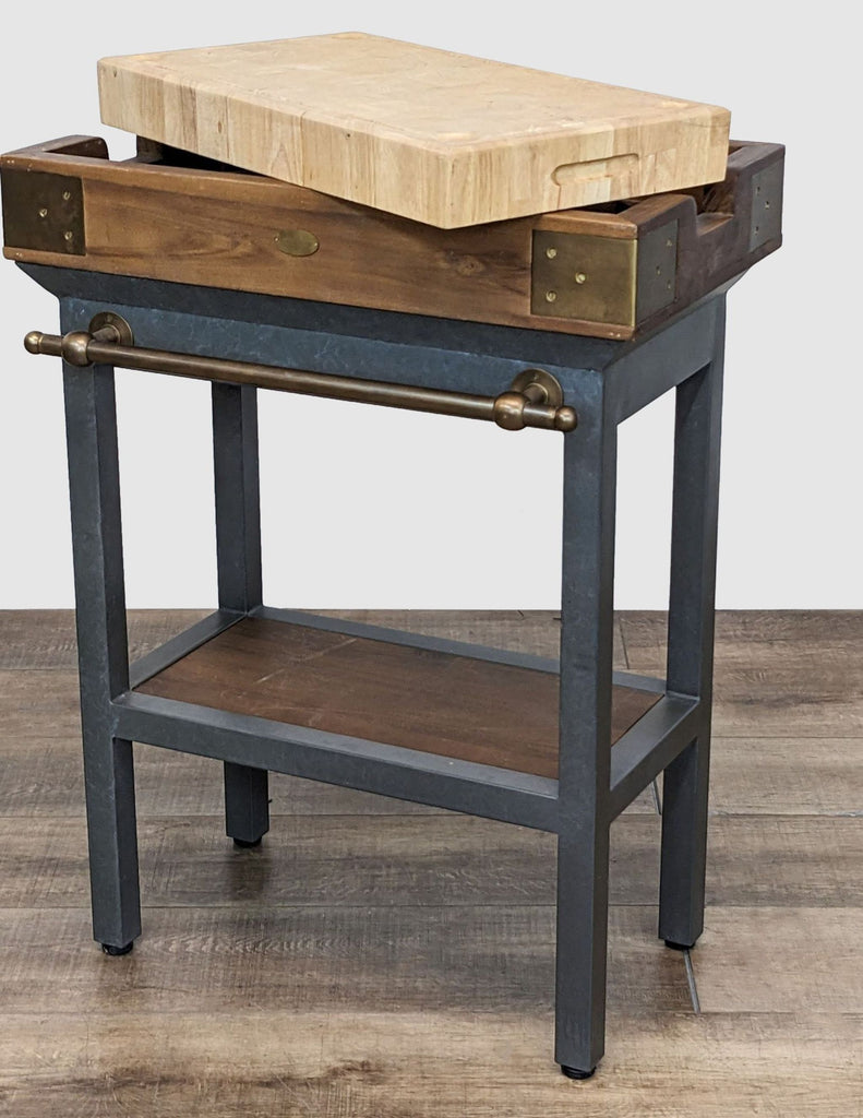 Gunmetal kitchen stand with open shelf, brass elements, and thick wooden butcher-block drawer.