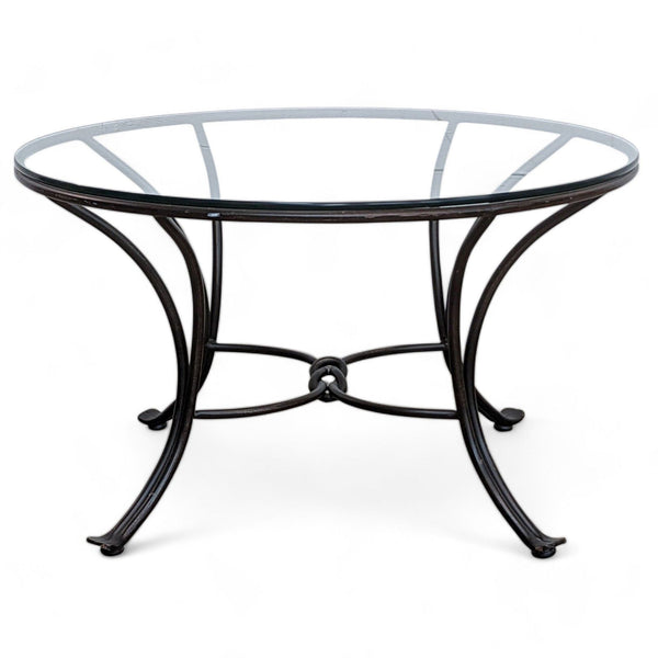 1. "Pier 1 Imports coffee table with a wrought iron base and a round glass top, isolated on white background."