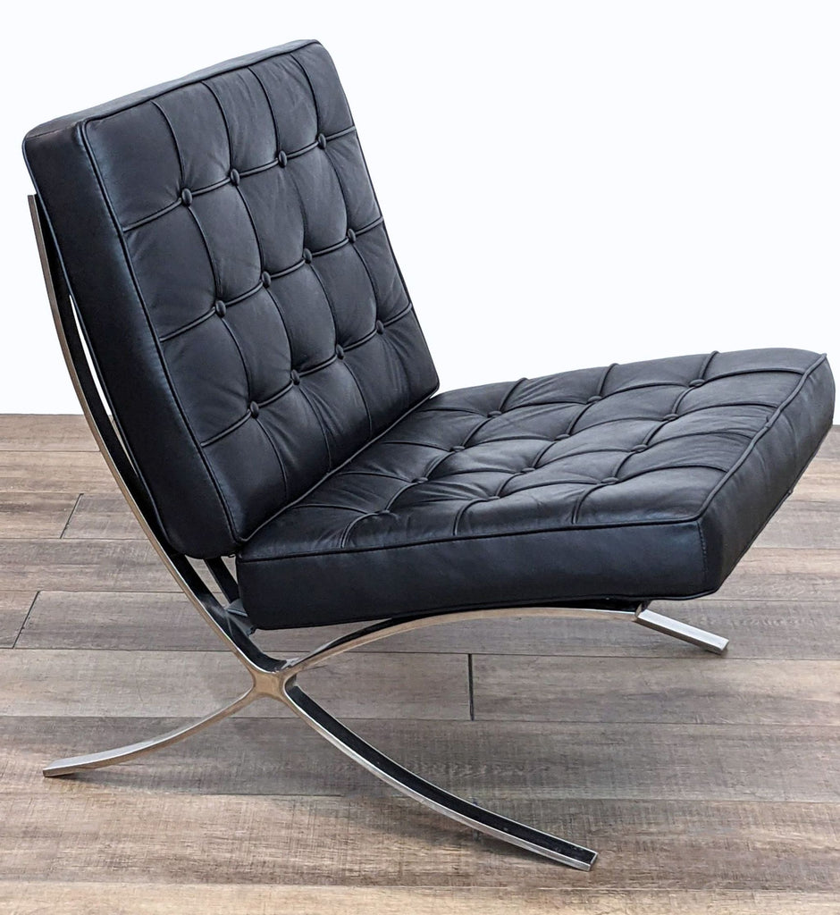 Angle view of the Reperch Barcelona chair replica featuring button tufting and sleek metal base.