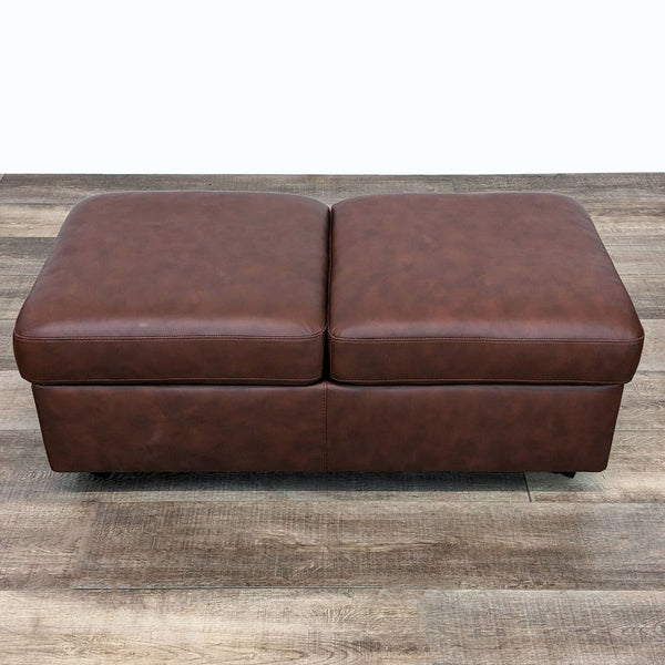 1. Scandinavian Design Ekornes leather ottoman in saddle color, 47", closed, on wooden floor.