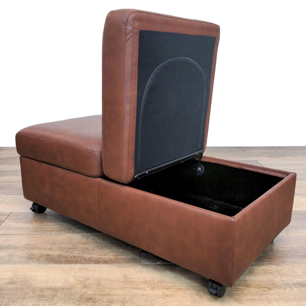 2. Opened Scandinavian Ekornes ottoman showing storage compartment, with casters visible.