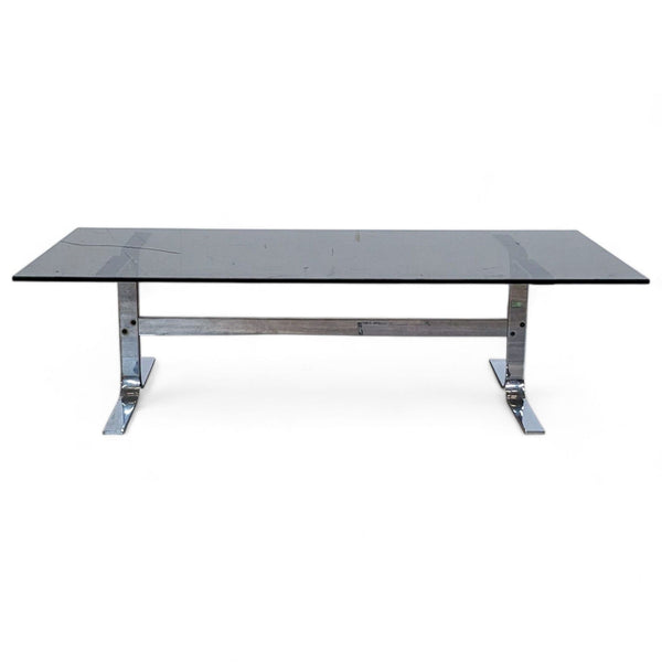 Reperch brand coffee table with a rectangular dark top and a shiny stainless steel trestle base.