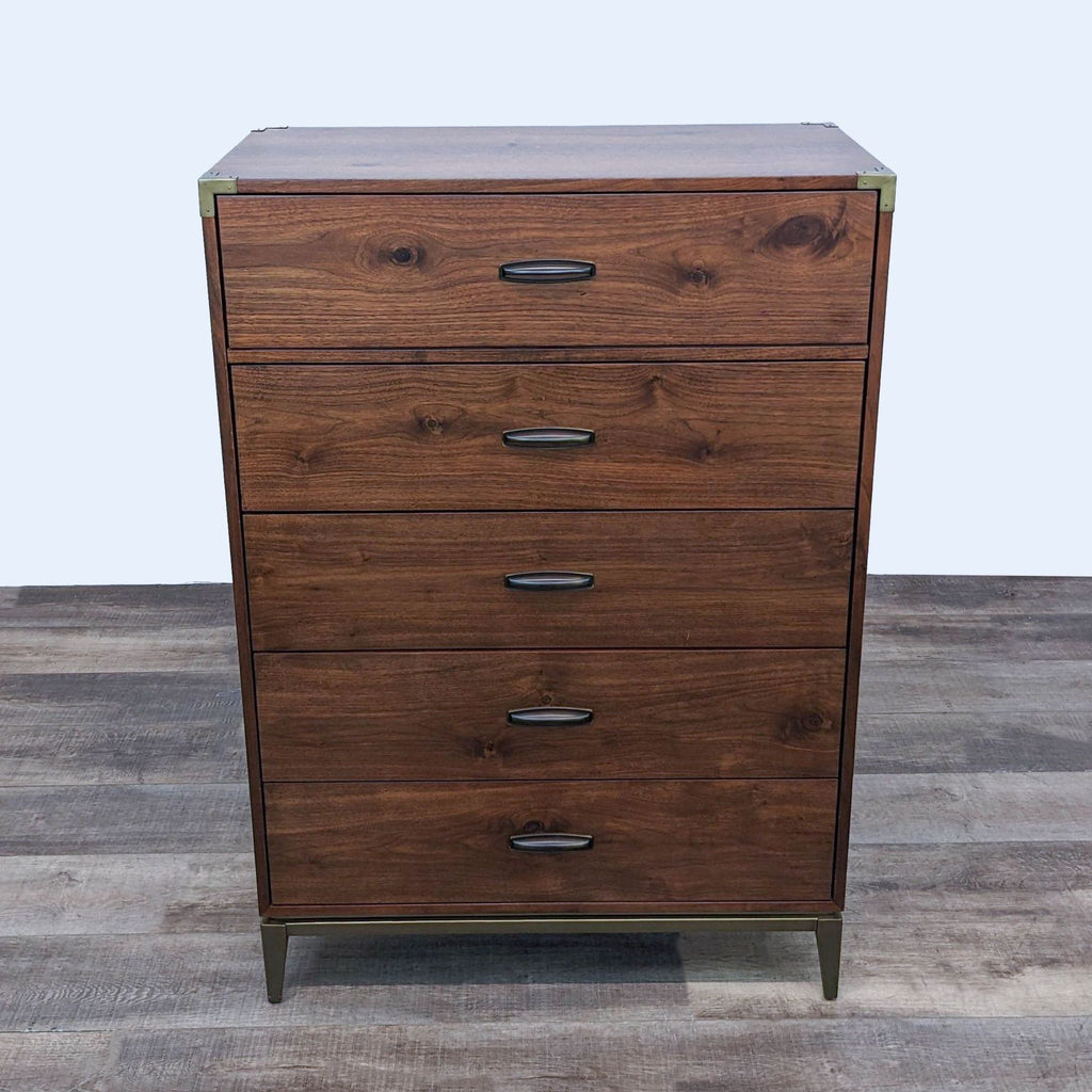 Alt text 3: Angled view of the Adler walnut veneer dresser with five drawers, brass detailing, and metal legs by Modus Furniture.
