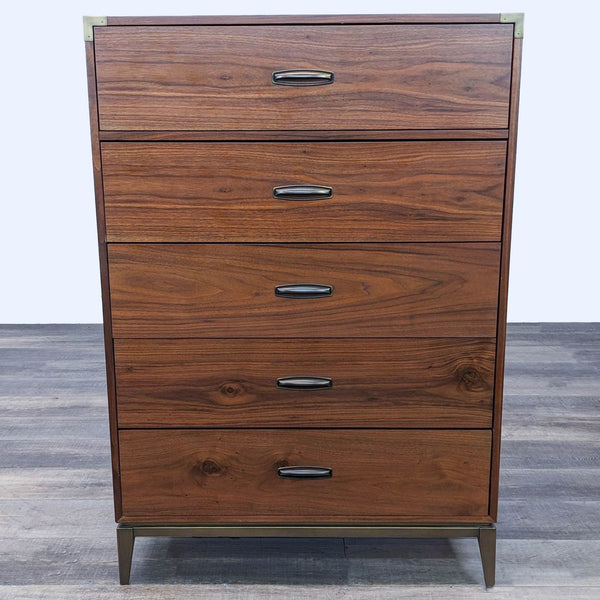 Alt text 1: Front view of the Adler 5-drawer dresser by Modus Furniture with walnut veneers and brass corner brackets.