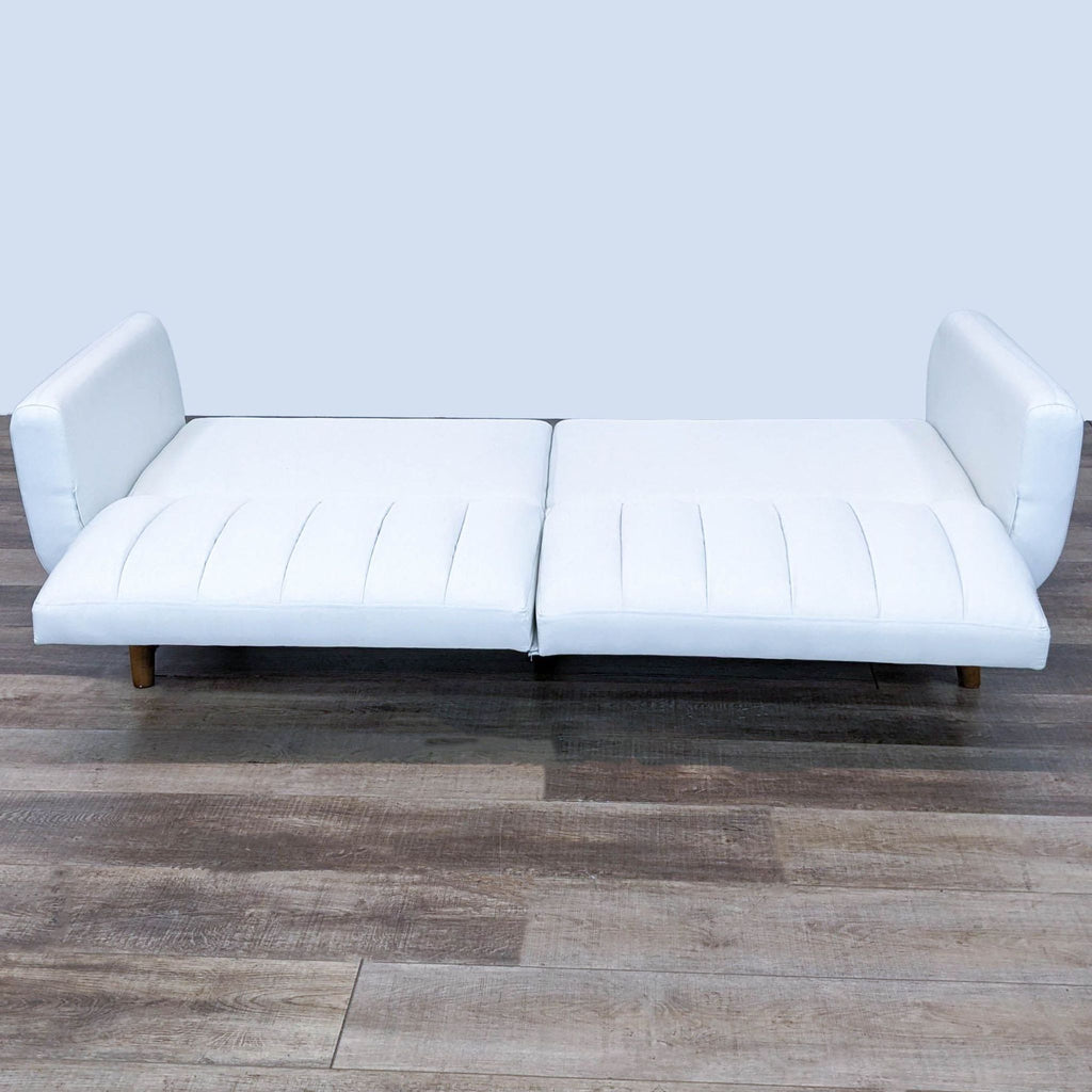 Alt text 2: The Dorel Home Furnishings Brittany futon displayed in a flat position, showcasing its multi-positional features on a wooden floor.