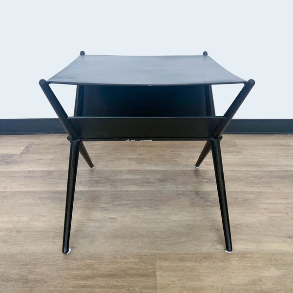 1. Front view of a modern Reperch side table with a square black top and angled metal legs against a wooden floor.