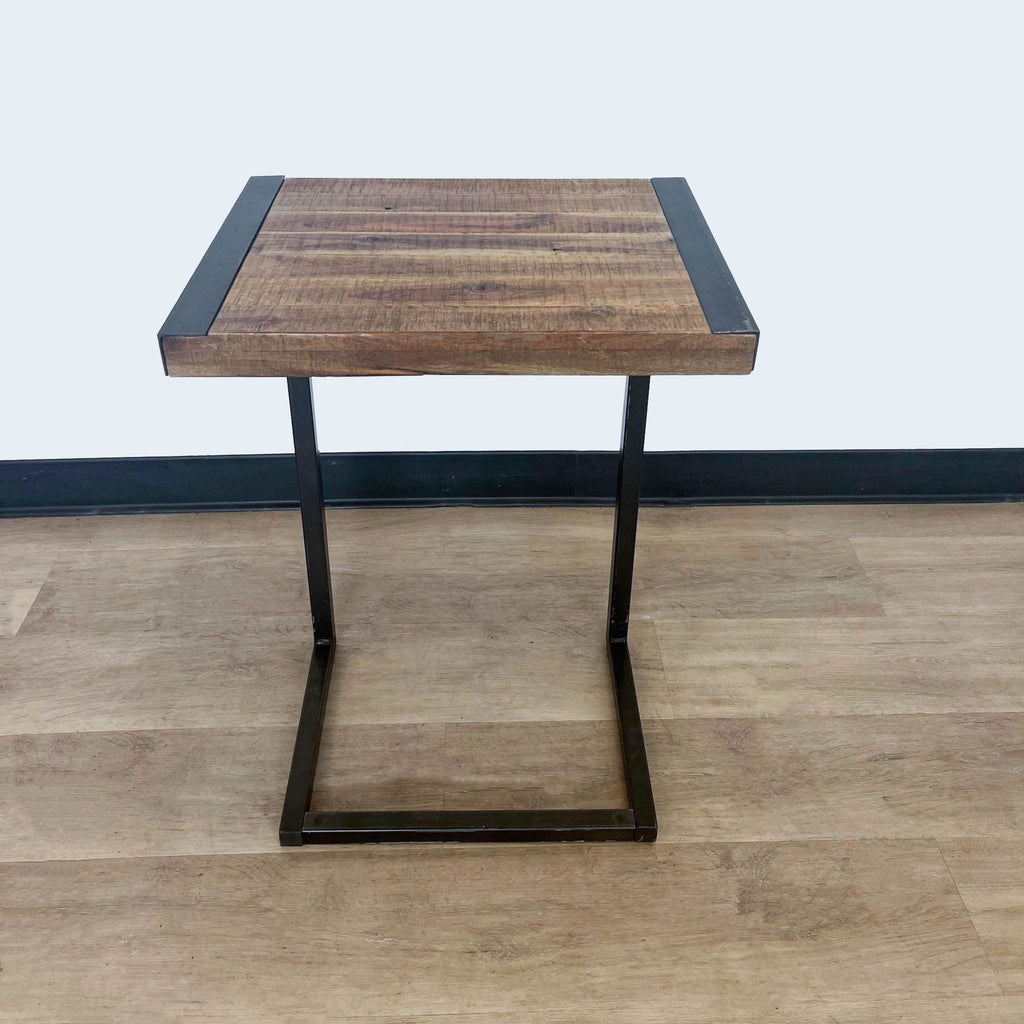 2. "Modern side table with brown wooden surface and metal frame, showcased from a corner angle, by World Market."