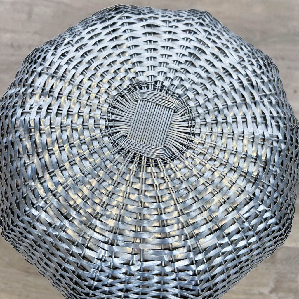 a large metal basket shaped table top