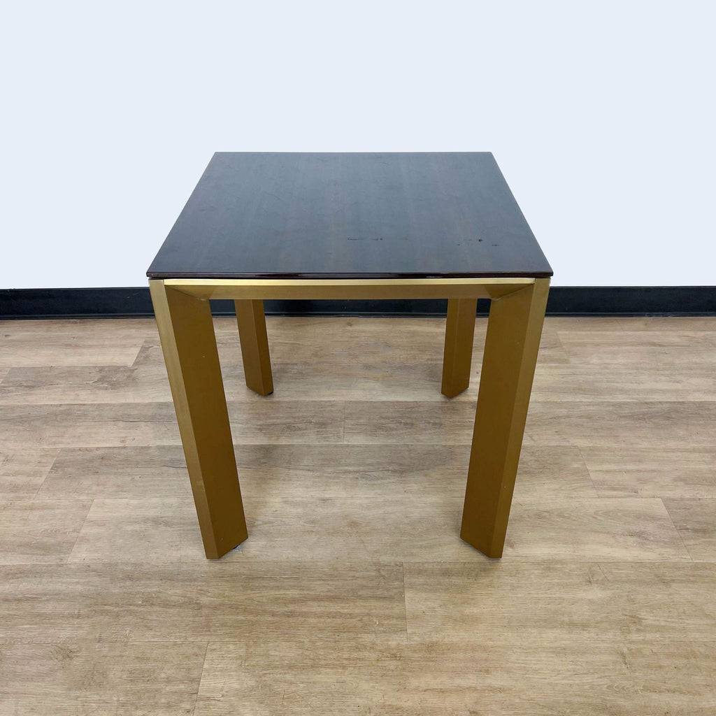 a black lacquered square table with a black top.