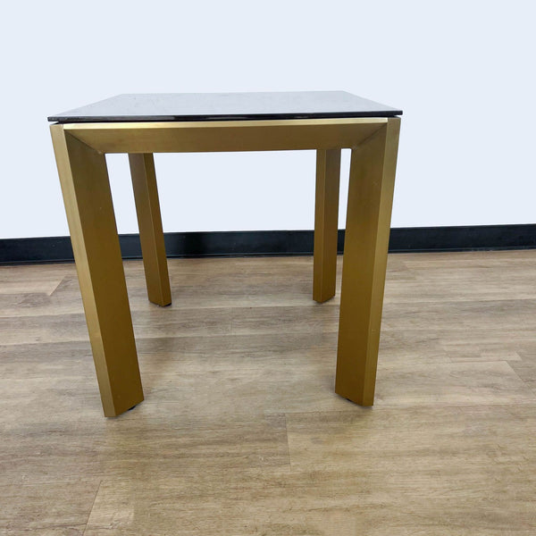 a pair of brass tables