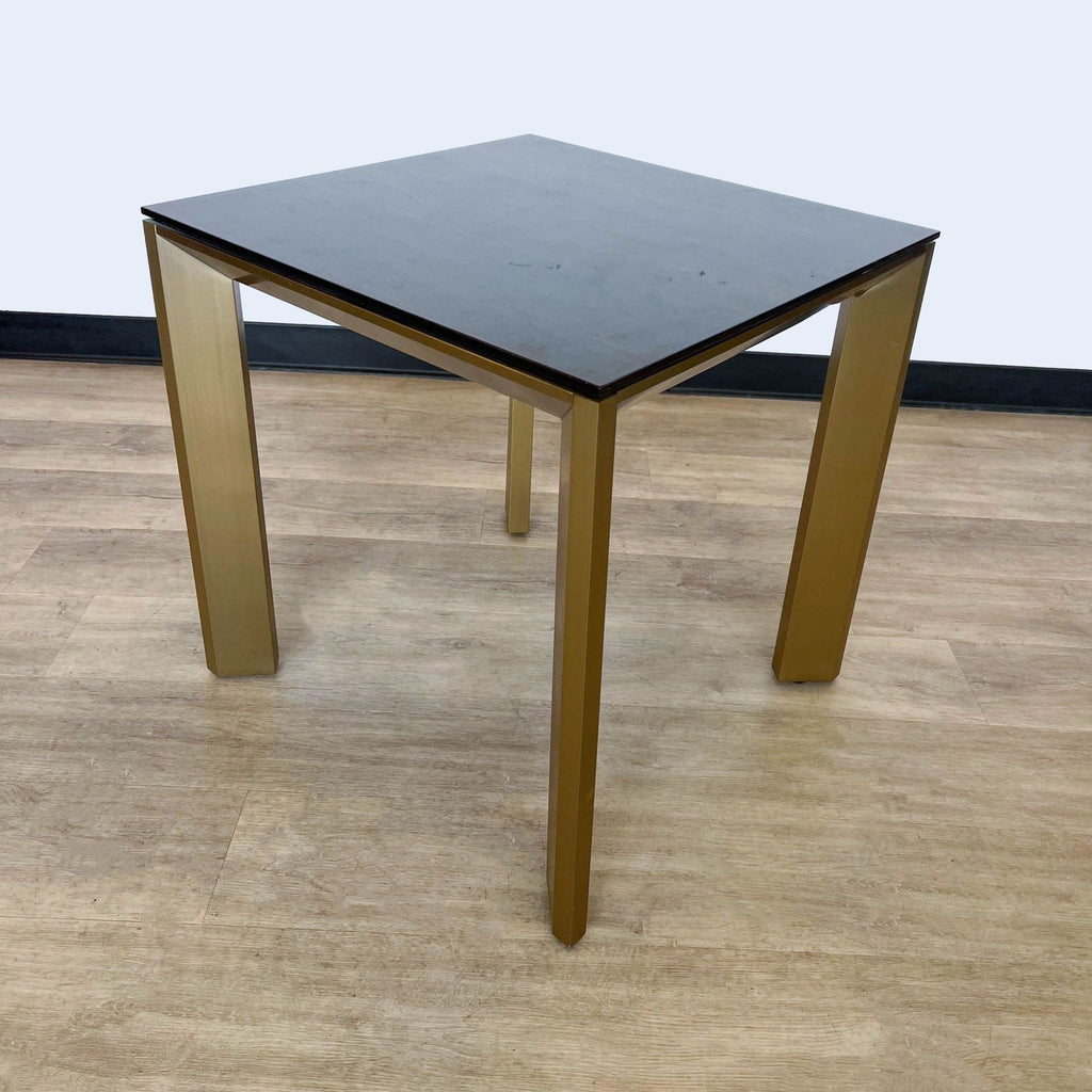 a pair of square square tables with a black marble top.